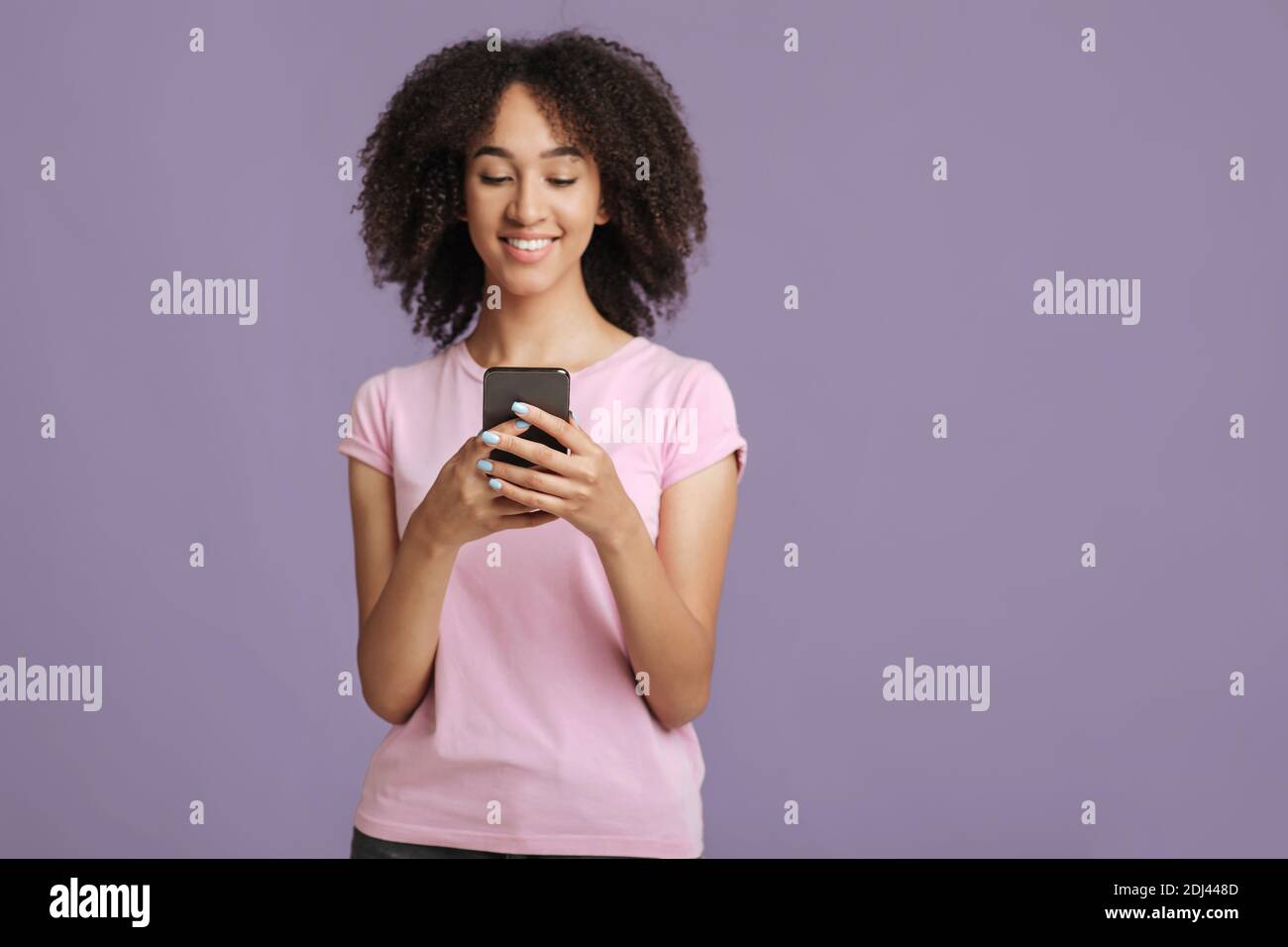 Texting message and modern blog. Smiling lady holding smartphone Stock Photo
