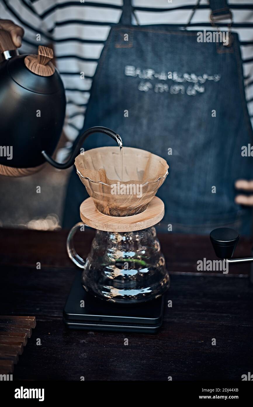 Hand drip coffee, Barista pouring water on coffee ground with filter