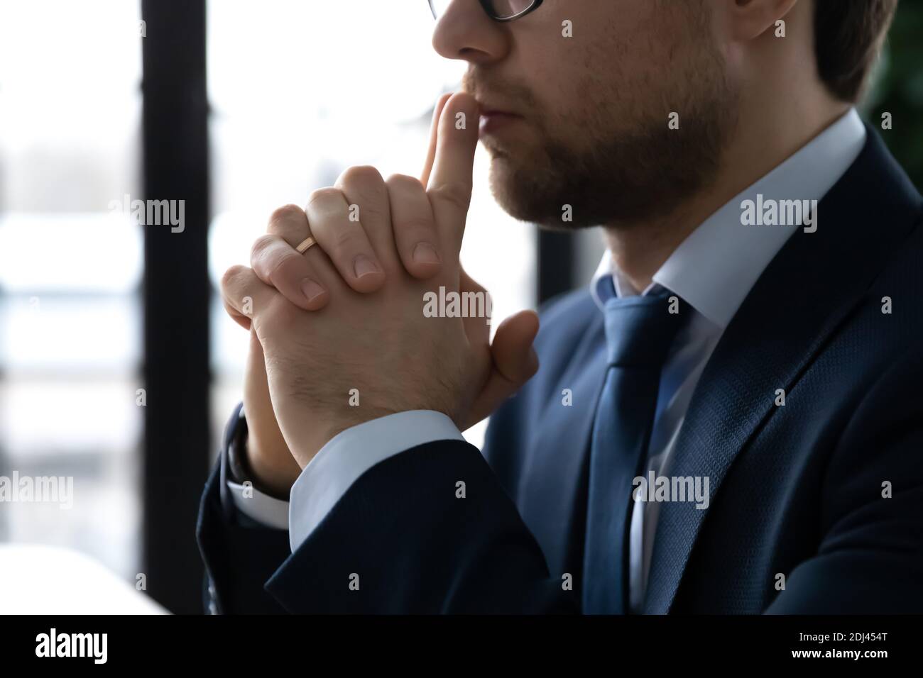 Close up side view thoughtful businessman pondering project strategy Stock Photo