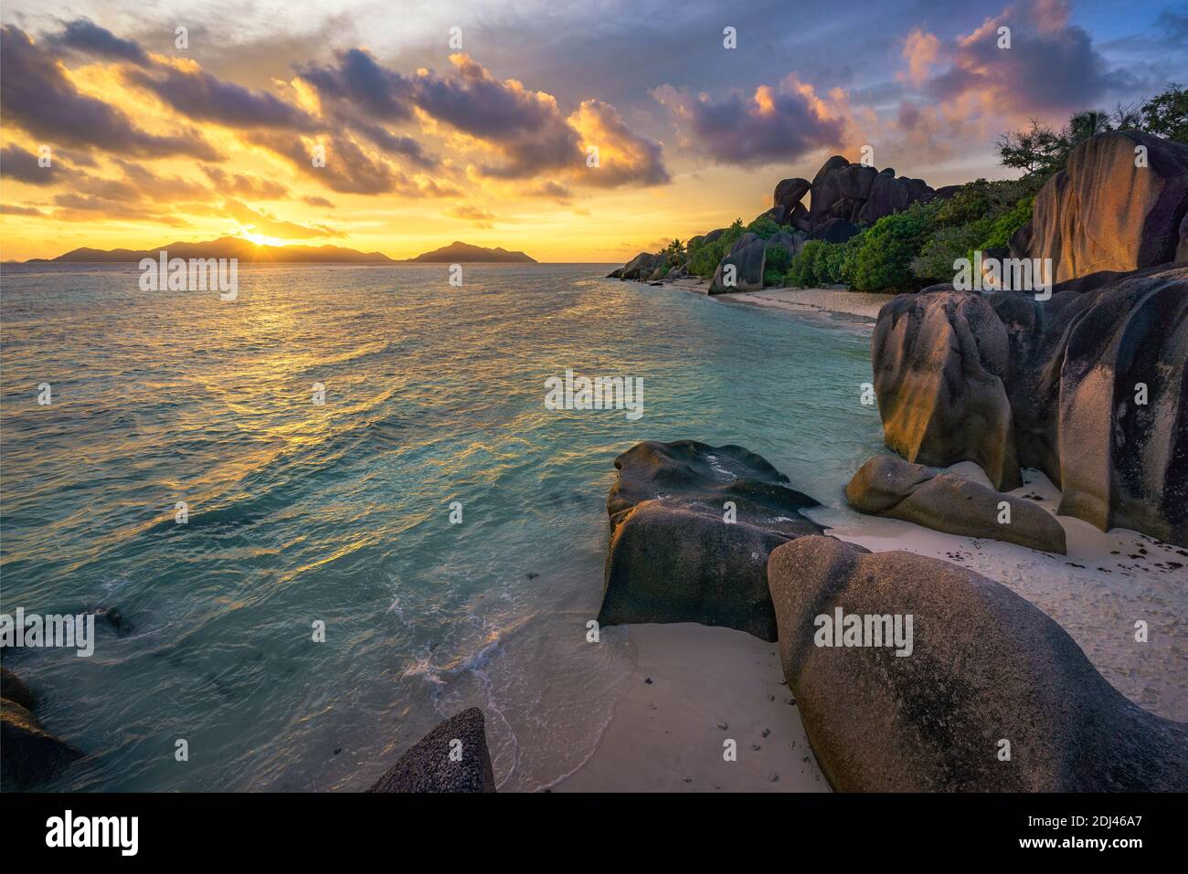 sunset at tropical beach anse source d'argent on la digue,seychelles ...