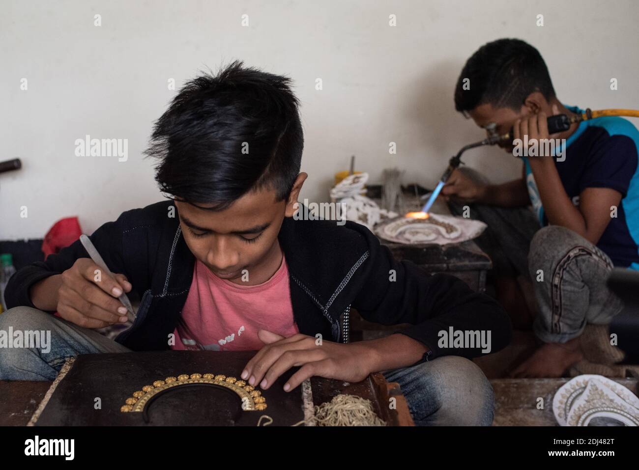 Dhaka, Bangladesh. 12th Dec, 2020. Workers making and sorting out copper and silver jewelry during Covid-19 outbreak at Bhakurta village in Savar on the outskirts of the capital. In total, there are 500 shops and households involved in the trade, providing livelihood to at least 2,500 families in Bhakurta and neighbouring villages. (Photo by Fatima Tuj Johora/Pacific Press) Credit: Pacific Press Media Production Corp./Alamy Live News Stock Photo