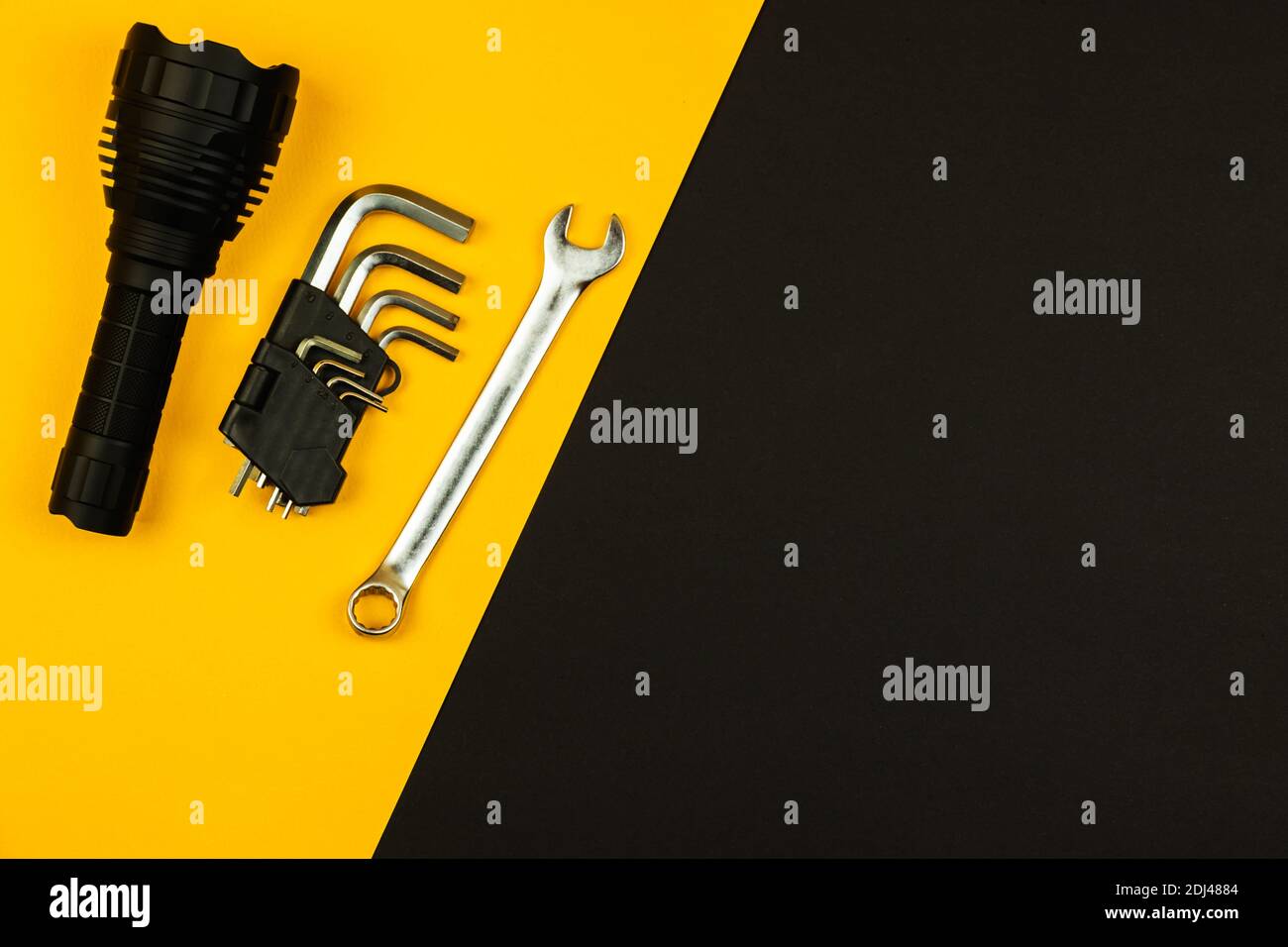 Tools set, flashlight and wrenches on a simple flat background, copy space photo Stock Photo