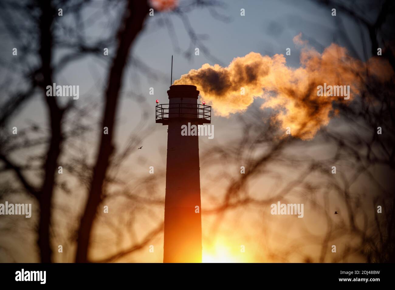Smoke from the chimney at sunset Stock Photo - Alamy