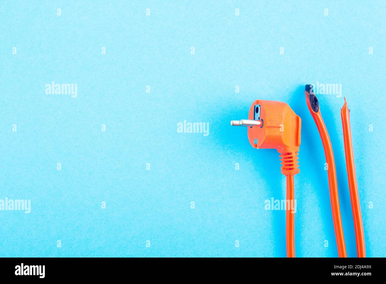 burnt electrical wire on blue background. Copy space Stock Photo Alamy