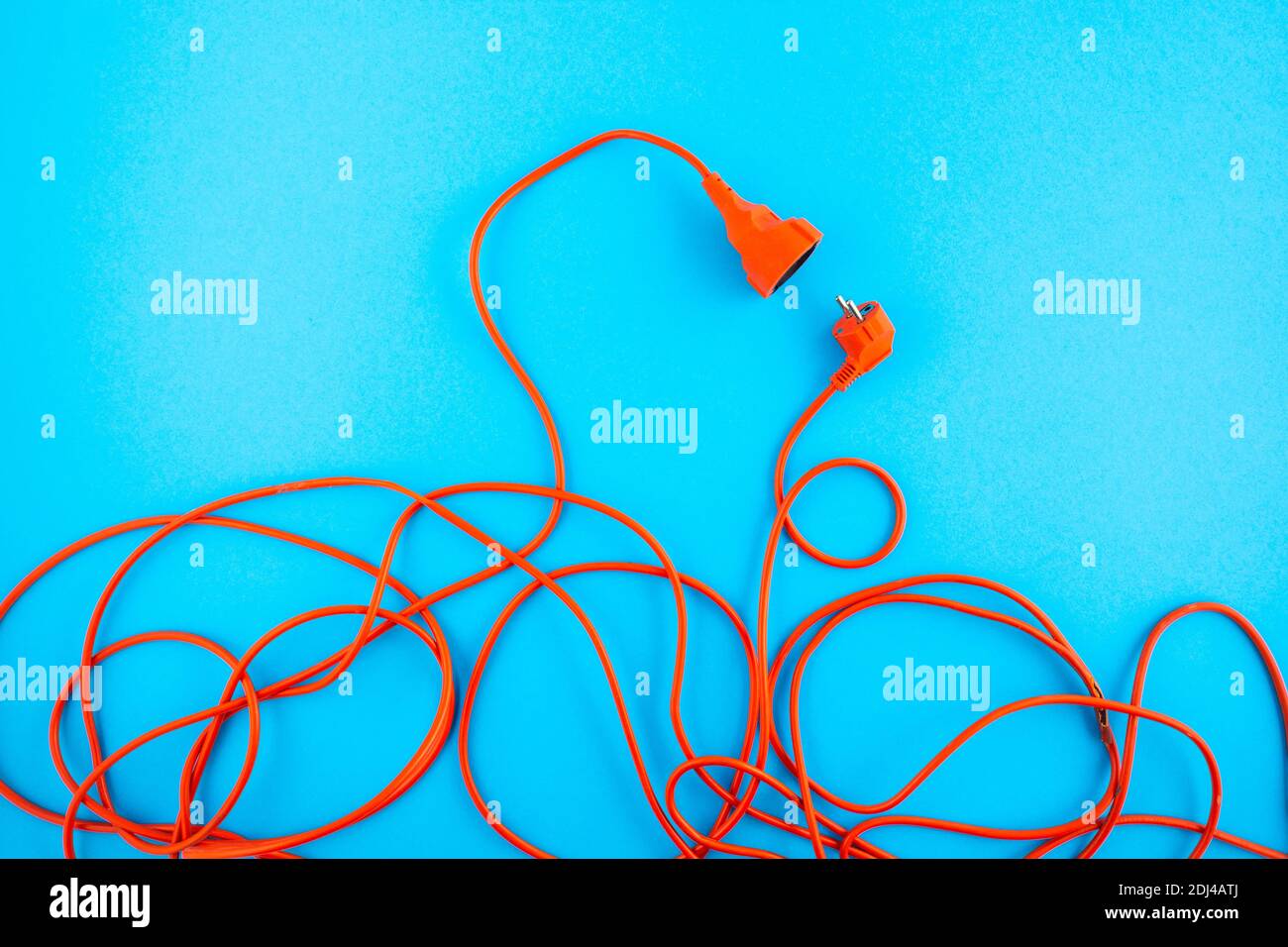 Orange electrical wire on blue background. connection concept Stock