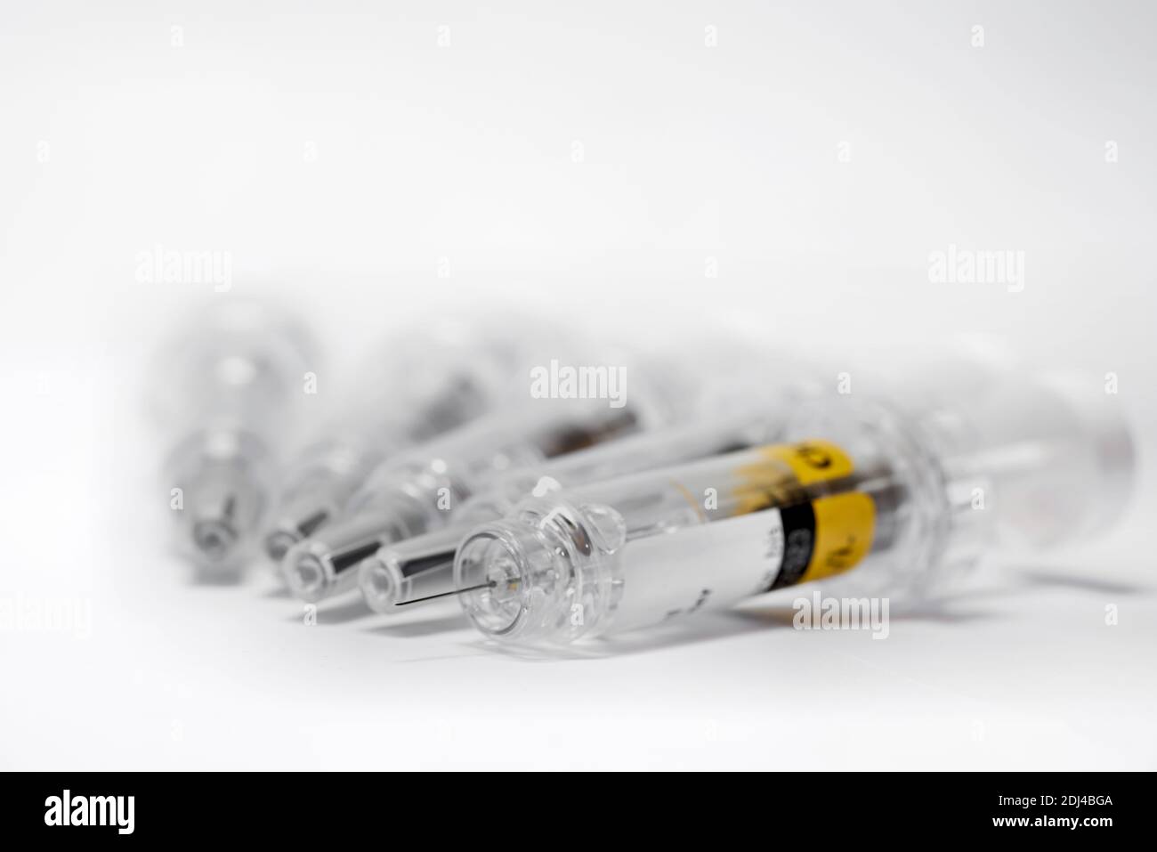 Syringe with vaccine to combat coronavirus on a table Stock Photo