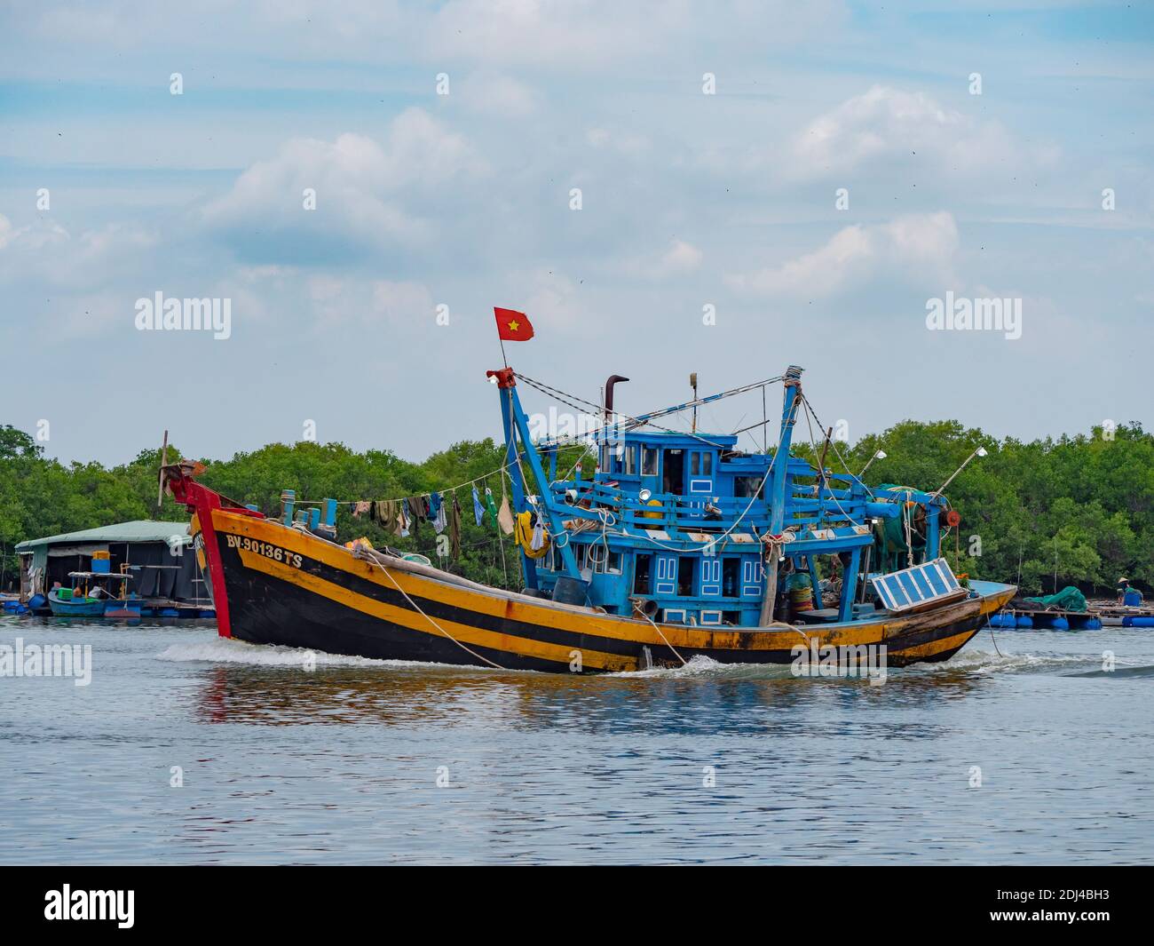 Fishing boat going down Dinh River near Vung Tau in the Bang Ria-Vung Tau Province of South Vietnam. Stock Photo