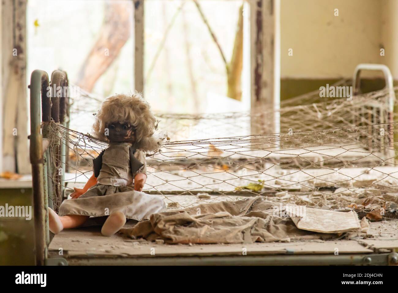 Scary doll on a bed in the kindergarten, a structure for children, a famous abandoned site in
