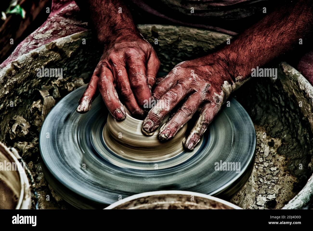 Hands of a potter forming clay on a potter's wheel Stock Photo