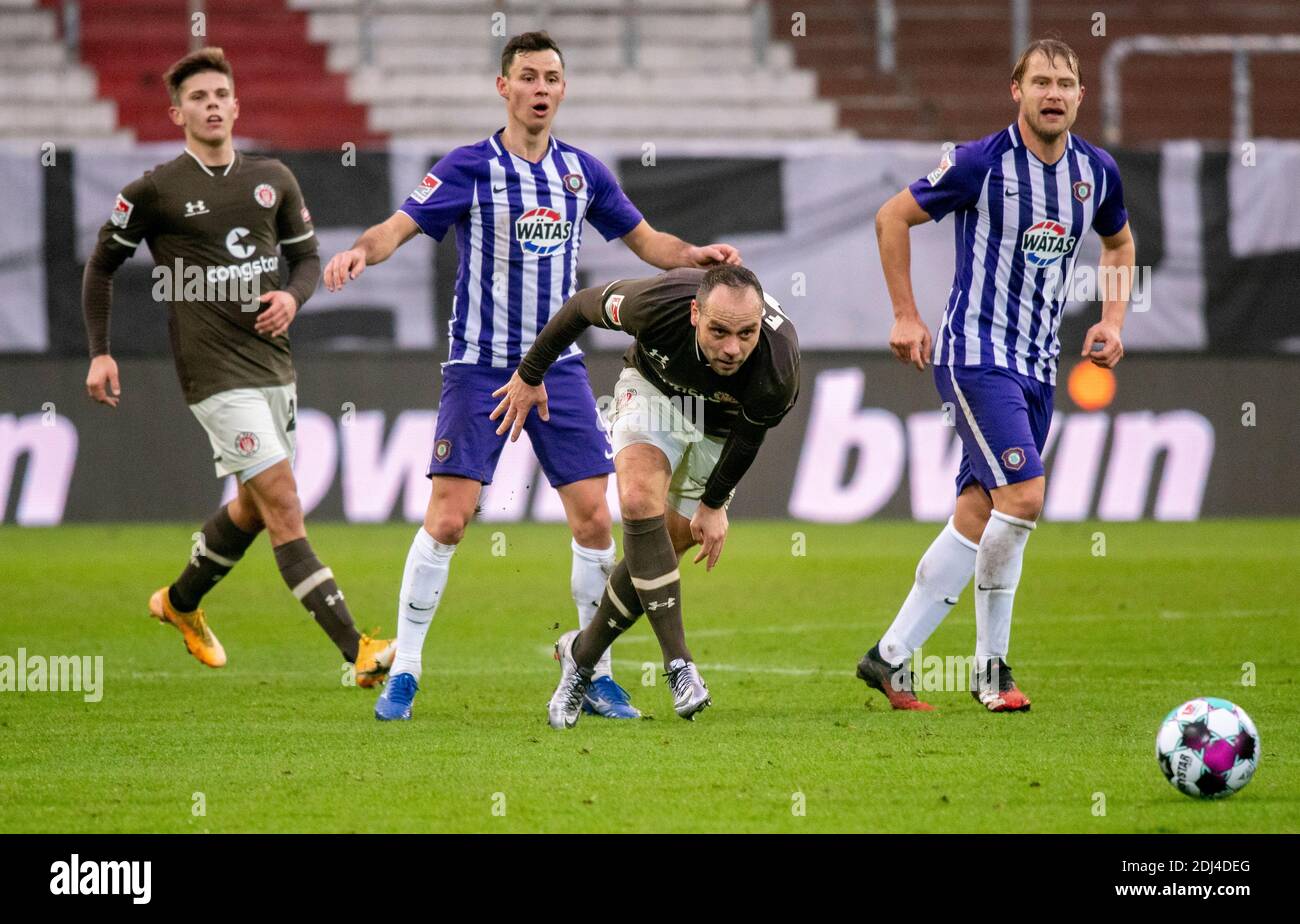 Hamburg, Germany. 13th Dec, 2020. Football: 2nd Bundesliga, FC St. Pauli - Erzgebirge Aue, 11th matchday. St. Paulis Finn Ole Becker (l-r), Aues Clemens Fandrich, St. Paulis Rico Benatelli and Aues Jan Hochscheidt fight for the ball. Credit: Axel Heimken/dpa - IMPORTANT NOTE: In accordance with the regulations of the DFL Deutsche Fußball Liga and the DFB Deutscher Fußball-Bund, it is prohibited to exploit or have exploited in the stadium and/or from the game taken photographs in the form of sequence images and/or video-like photo series./dpa/Alamy Live News Stock Photo