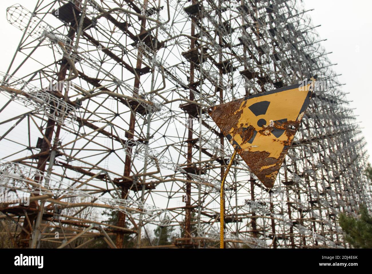 Rusty nuclear hazard sign in front of Duga system, a Soviet over the horizon in the Chernobyl exclusion area. Stock Photo