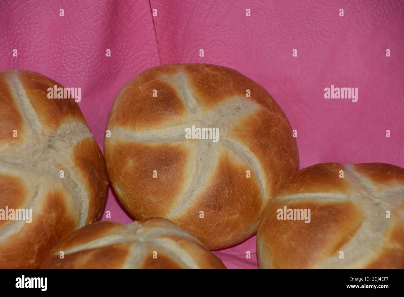 homemade wheat bread rolls on pink napkins close-up Stock Photo