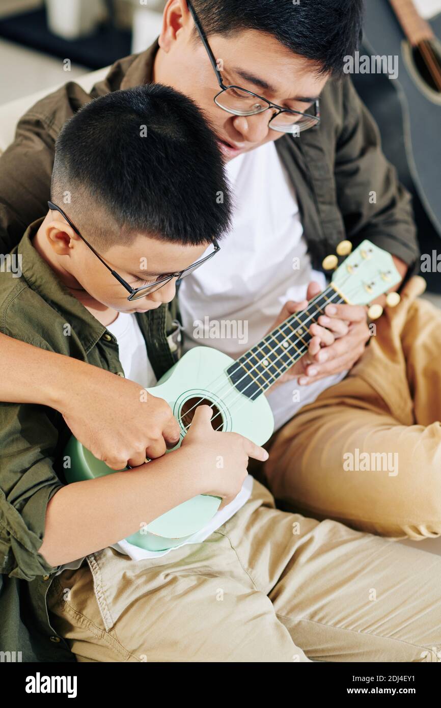Learning how to play ukulele Stock Photo Alamy