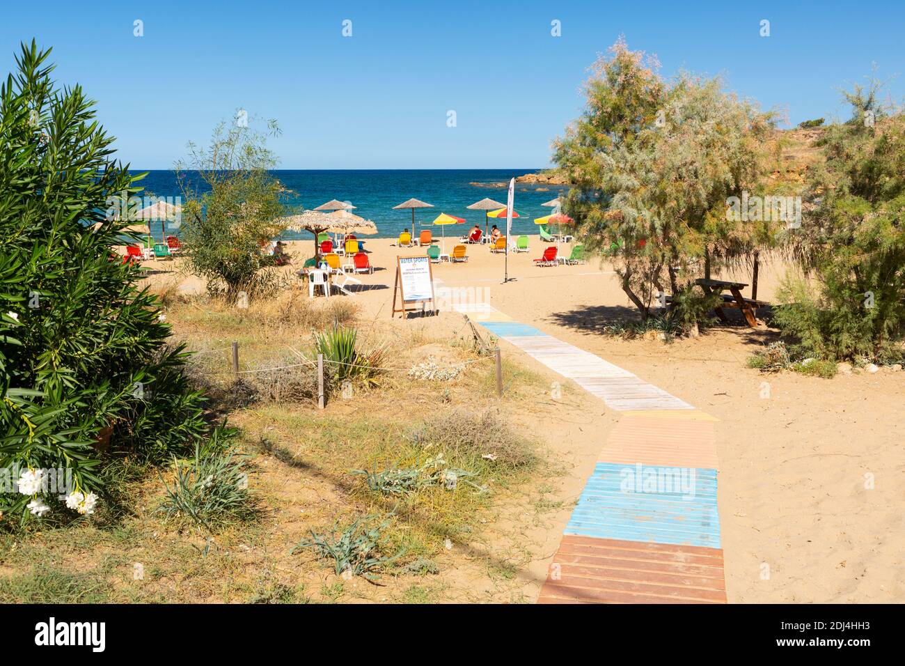 Wooden walkway across the sand to Iguana Beach (Agii Apostoli Beach), Chania, Crete, Greece Stock Photo