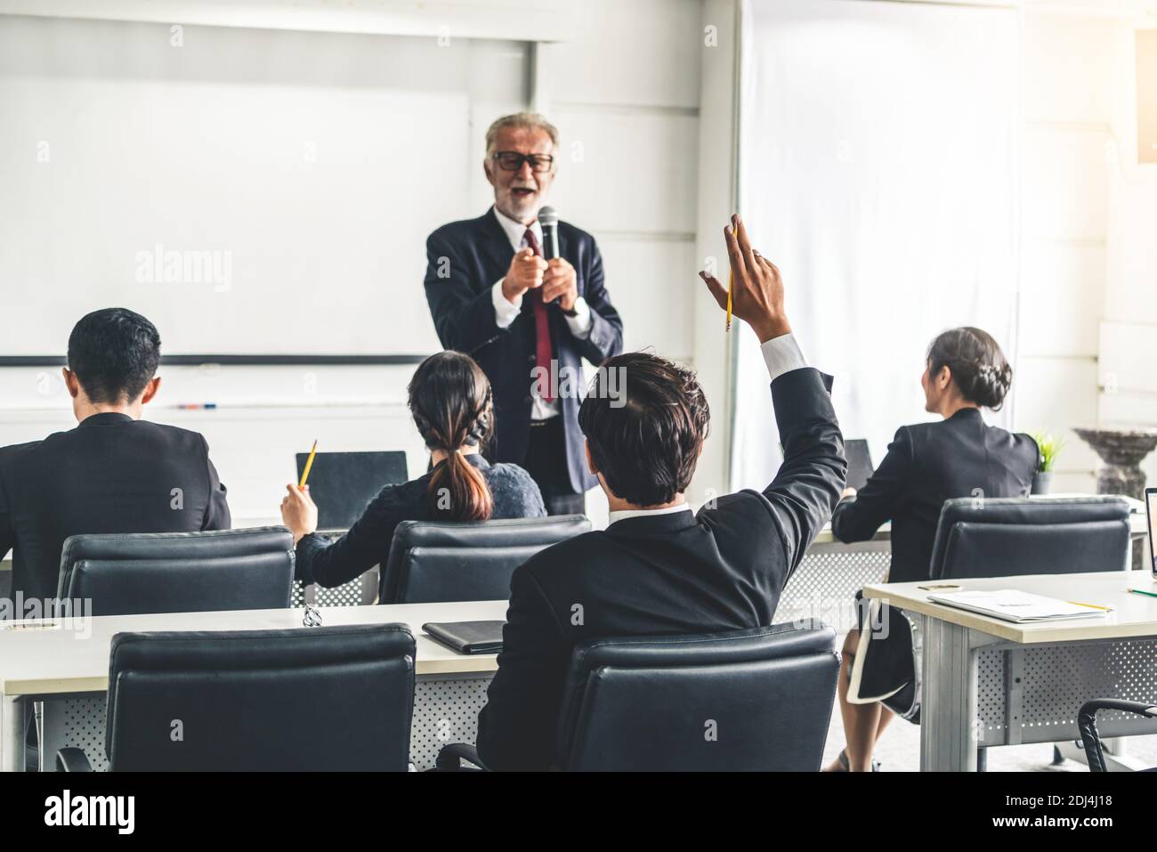 Senior leader speaker speaks to public people audience in training