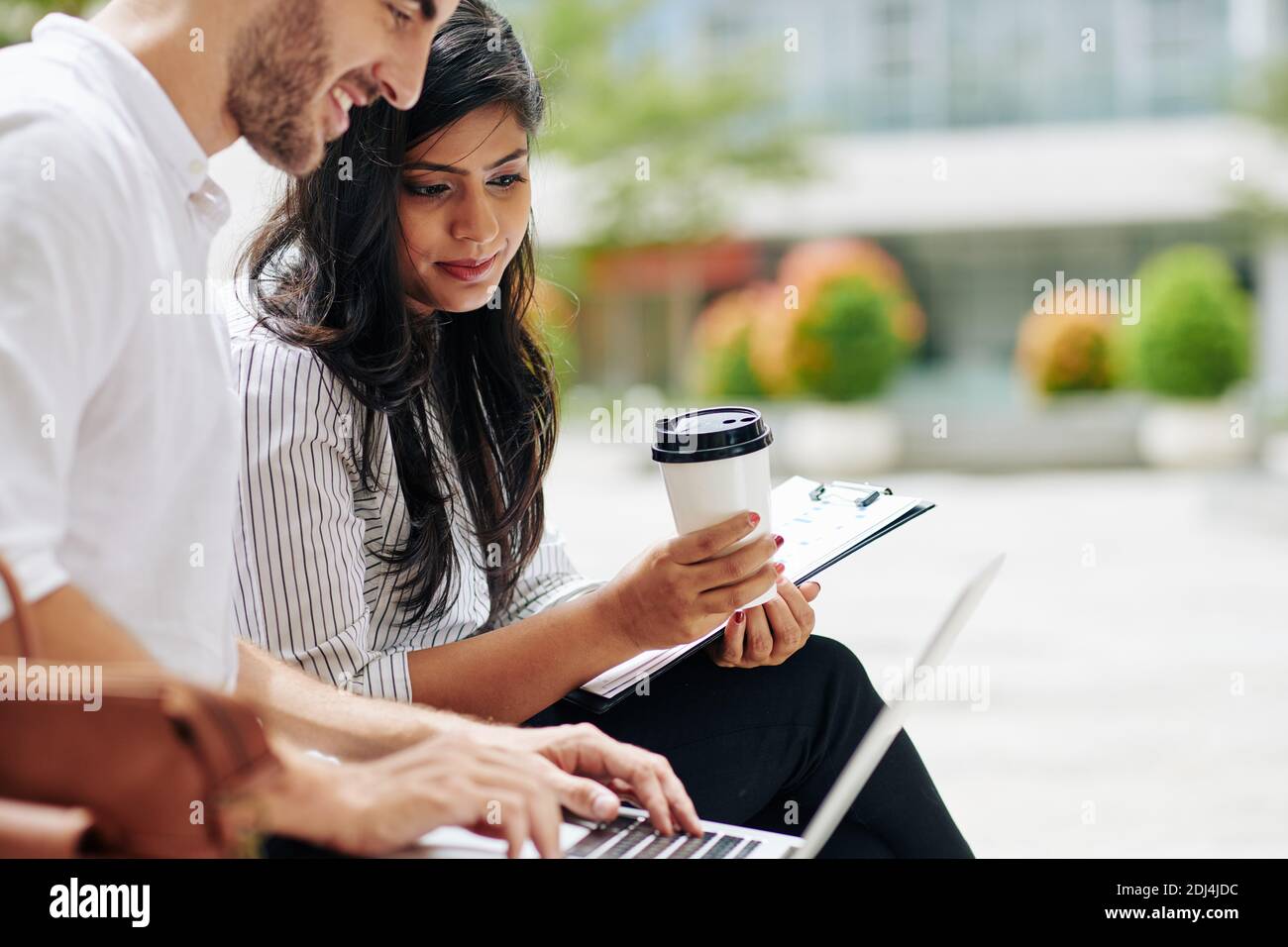 Business people having meeting outdoors Stock Photo