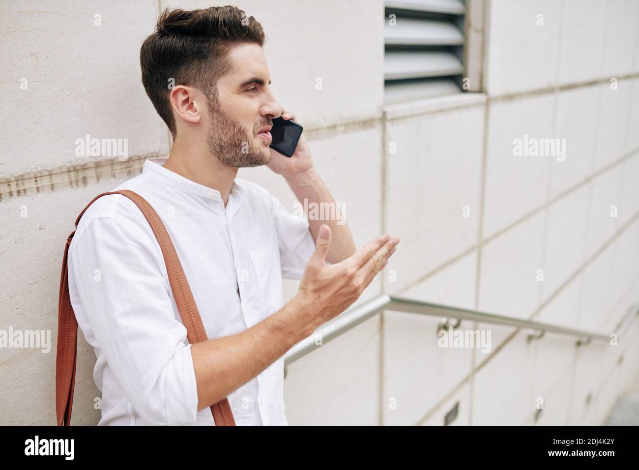 Bearded man talking on phone Stock Photo