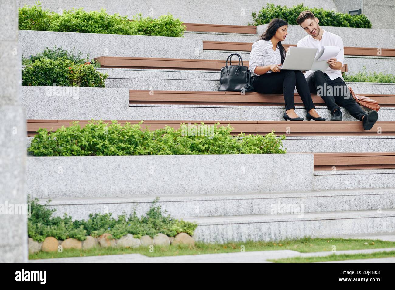 Business people sitting on bench hi-res stock photography and images ...