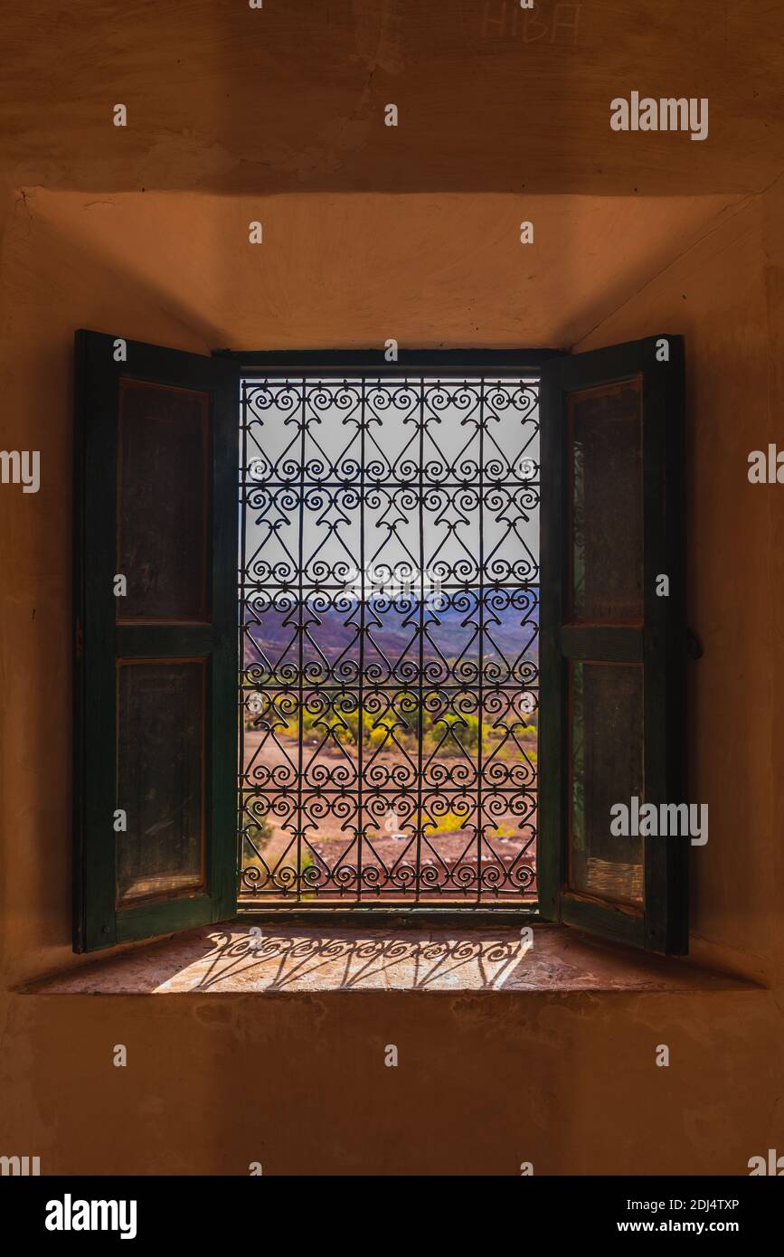 Glaoui Kasbah in the moroccan Atlas, view through a wrought iron window Stock Photo
