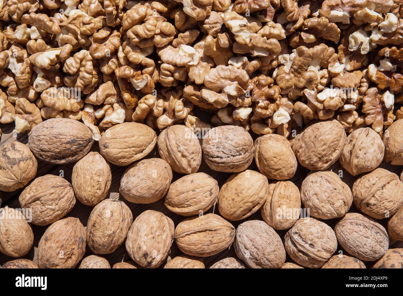 Walnut kernels and whole walnuts Stock Photo
