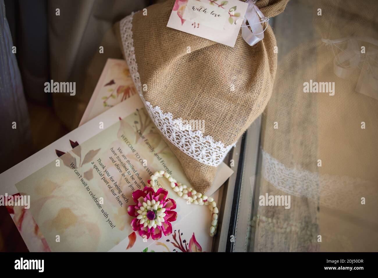 marriage invitation card with beautiful jute bag and flowers Stock