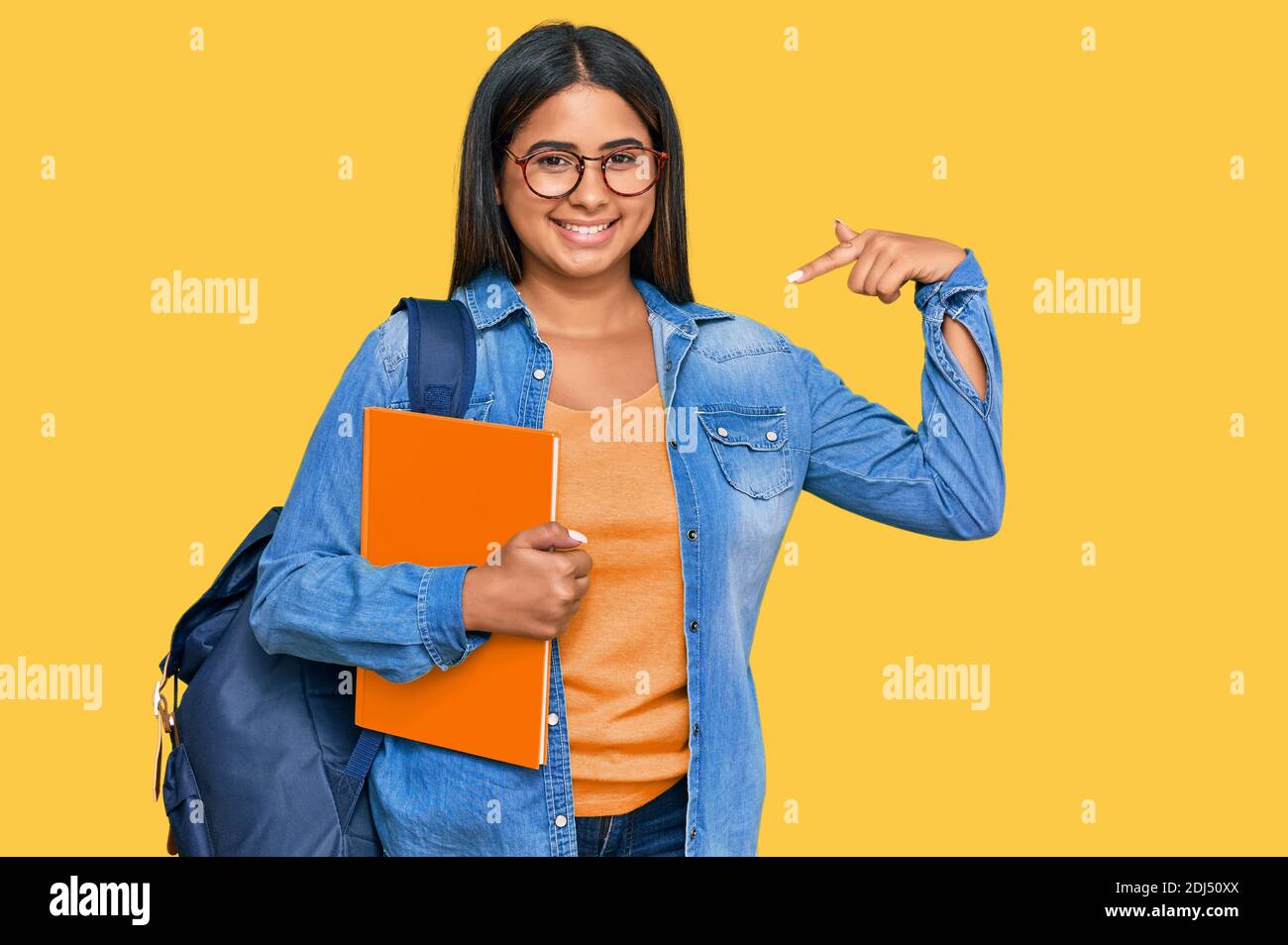 Young latin girl wearing student backpack and holding books looking ...