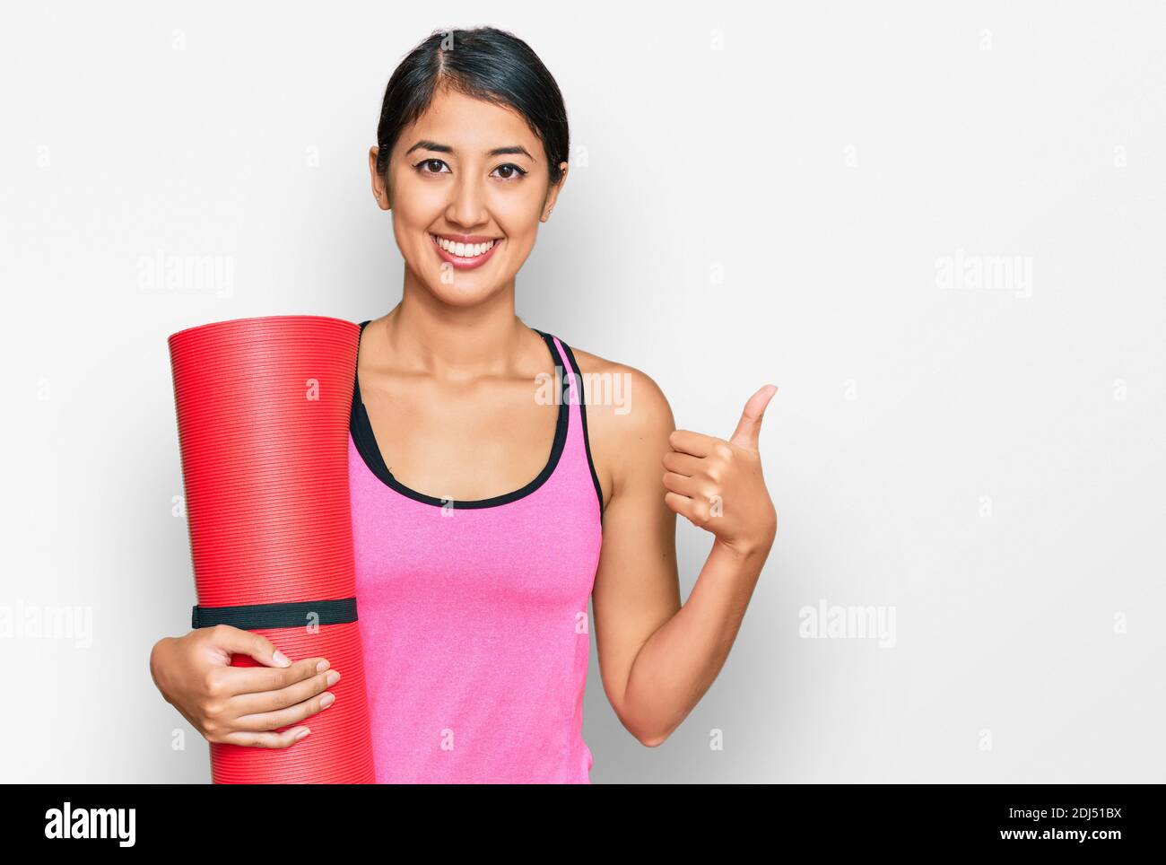Beautiful asian young sport woman holding yoga mat smiling happy and ...