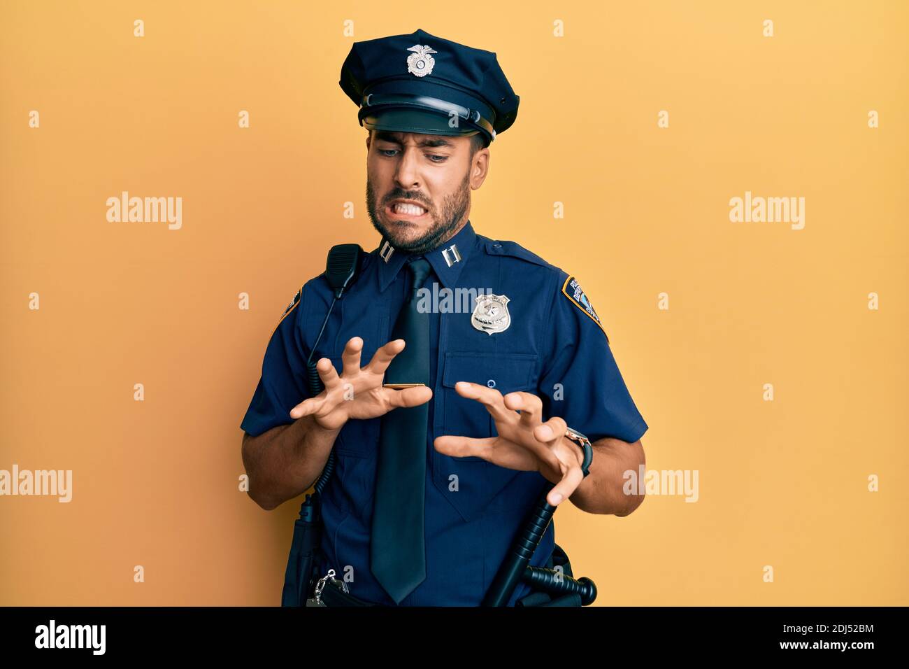 Handsome hispanic man wearing police uniform disgusted expression ...