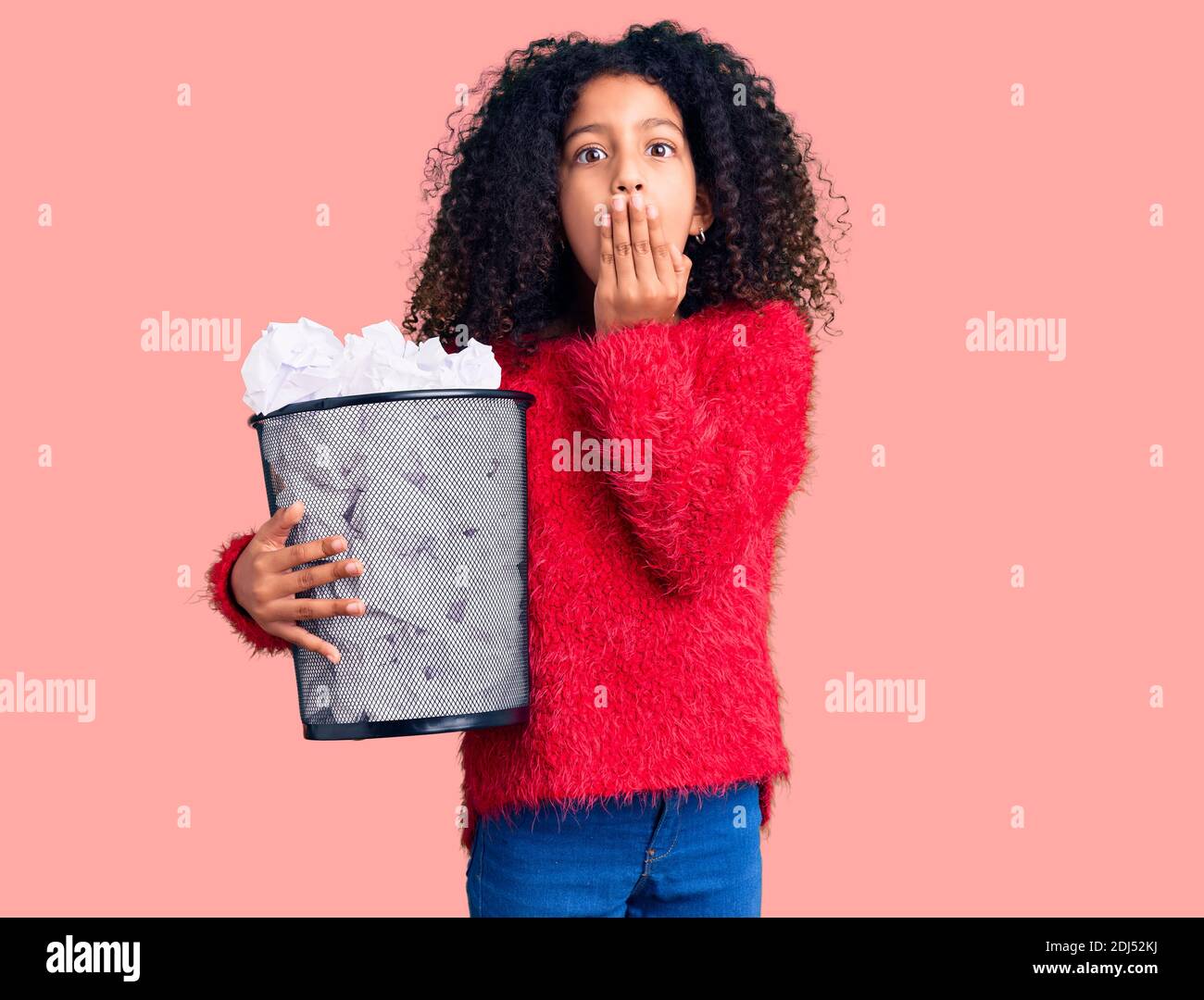 Afraid Paper African american child with curly hair holding paper bin full of ...