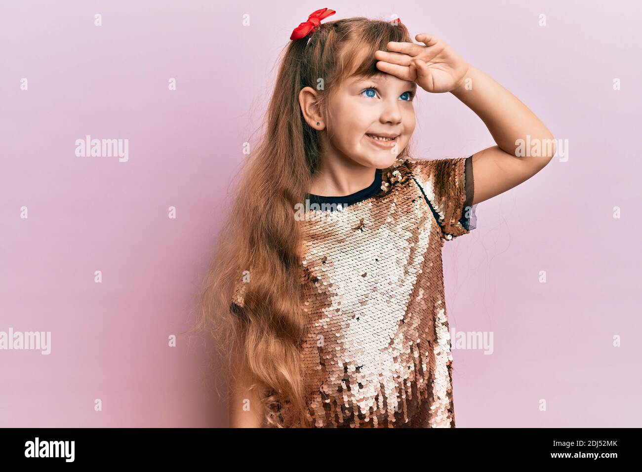Little caucasian girl kid wearing festive sequins dress very happy and ...