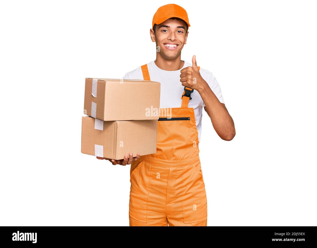 Young handsome african american man holding delivery package smiling ...