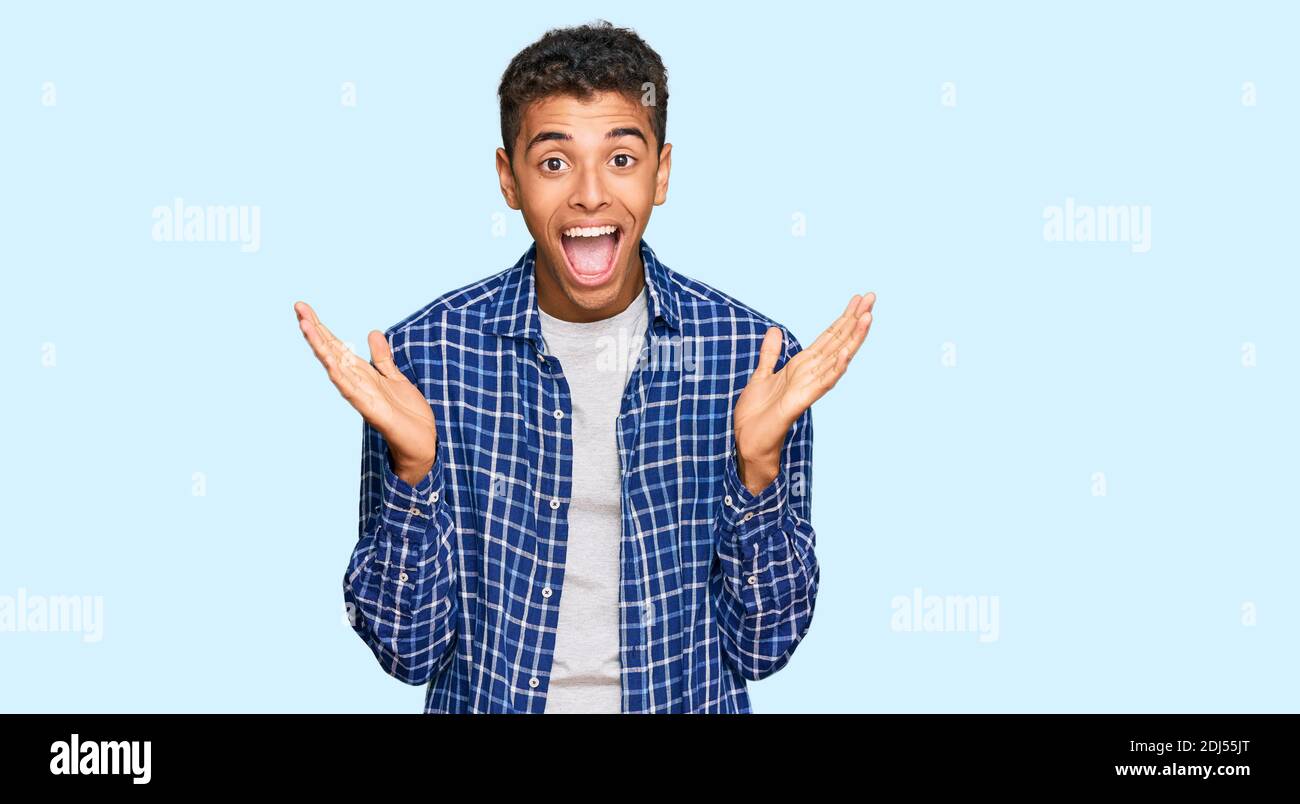 Young handsome african american man wearing casual clothes celebrating ...