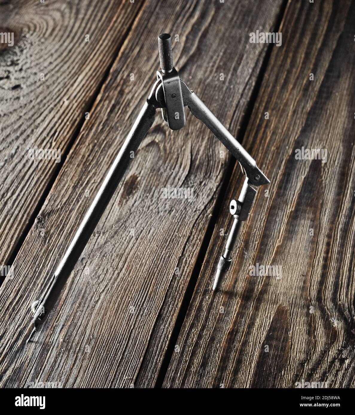Metal compasses on a wooden table. Stock Photo