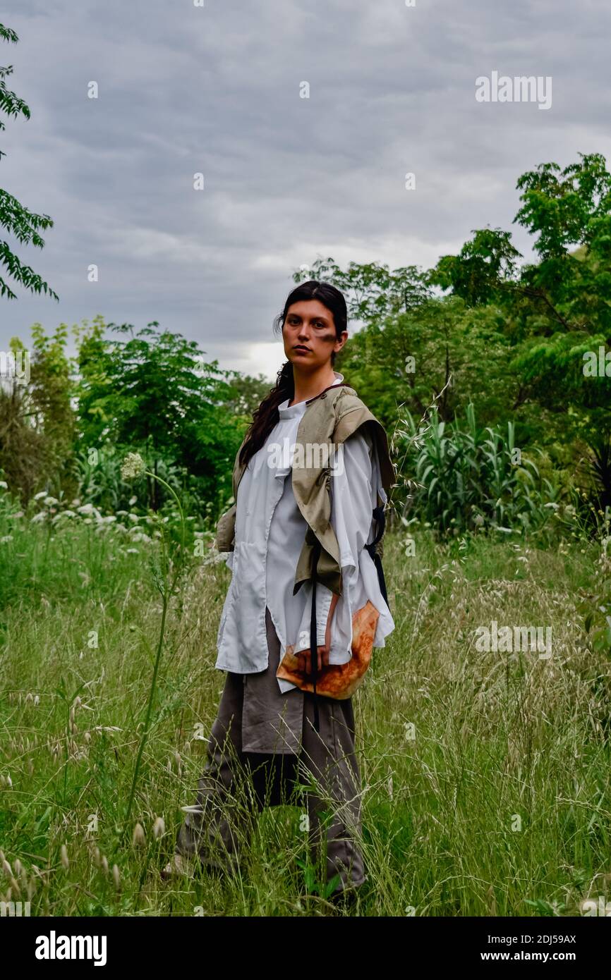 Female farmer looking at green corn maize crop field in summer Stock ...