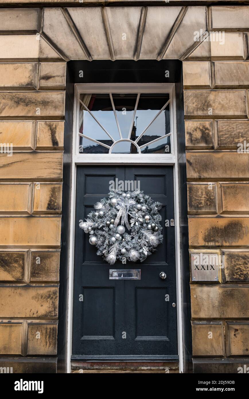Decorative Christmas wreath on panelled front door number 29 of Georgian townhouse, Edinburgh New Town, Scotland, UK Stock Photo