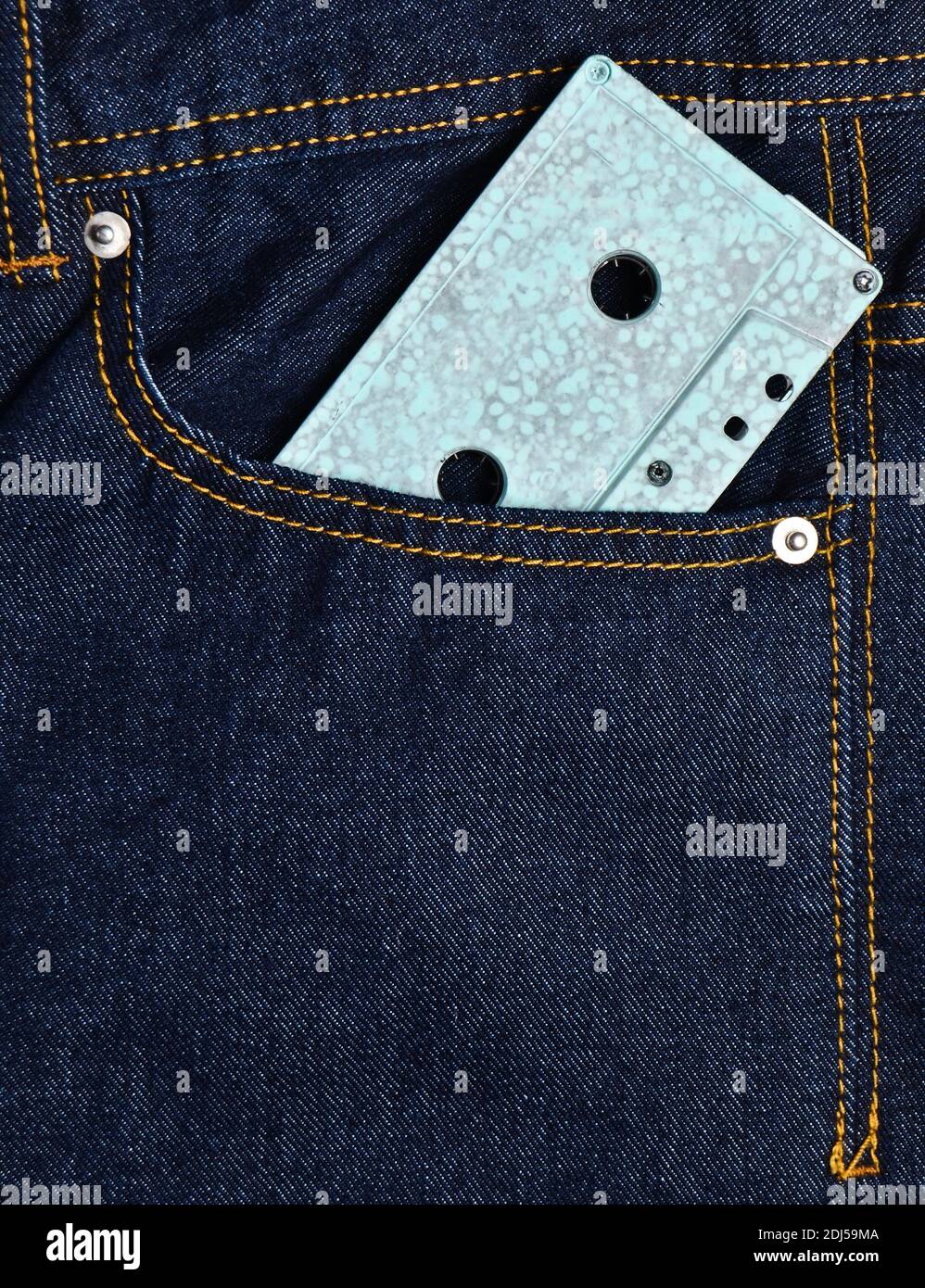 Blue audio cassette in the front pocket of the jeans Stock Photo Alamy