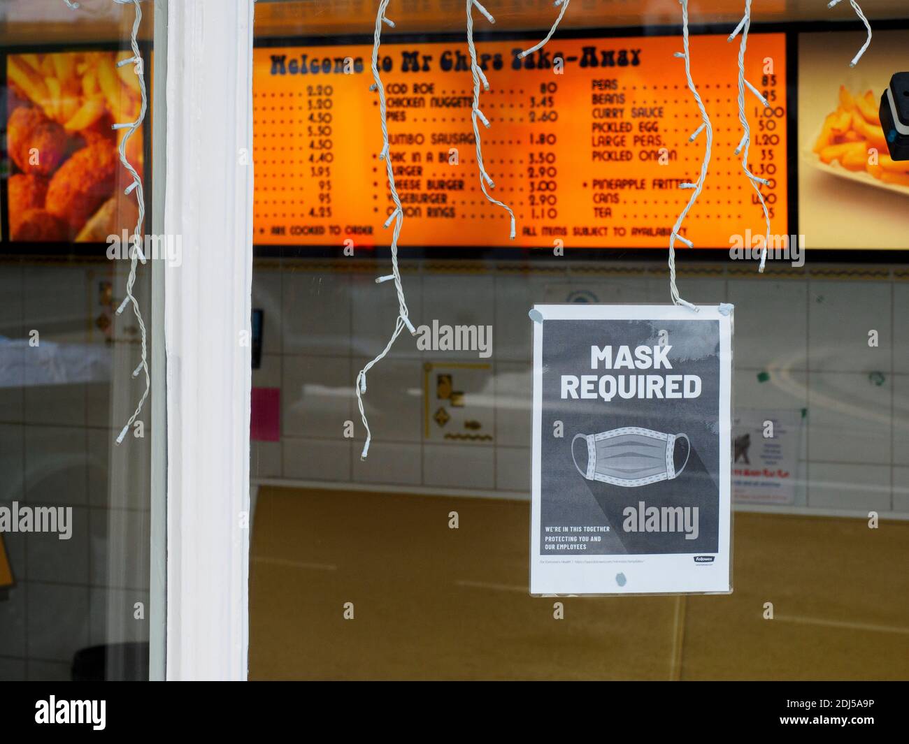 Mask Required sign on window of a fish and chip take-away shop, Bideford, Devon, UK, 2020 Stock Photo