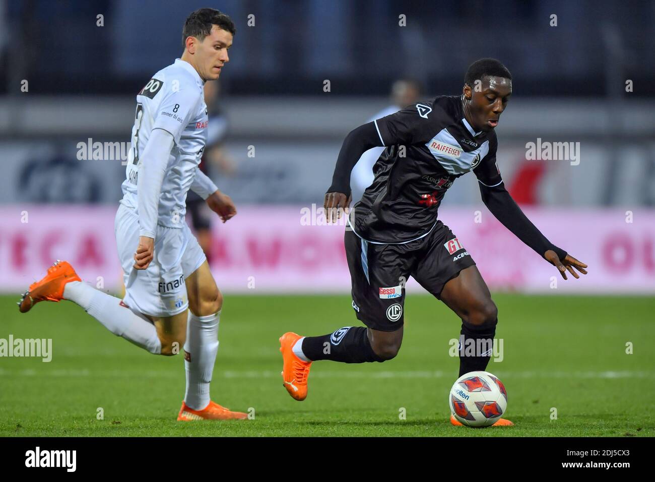 Lugano, Switzerland. 13th Dec, 2020. Cristopher Lungoyi (#8 FC Lugano) and Nathan (#3 Zurich) in action during the Swiss Super League match between FC Lugano and FC Zürich Cristiano Mazzi/SPP Credit: SPP Sport Press Photo. /Alamy Live News Stock Photo