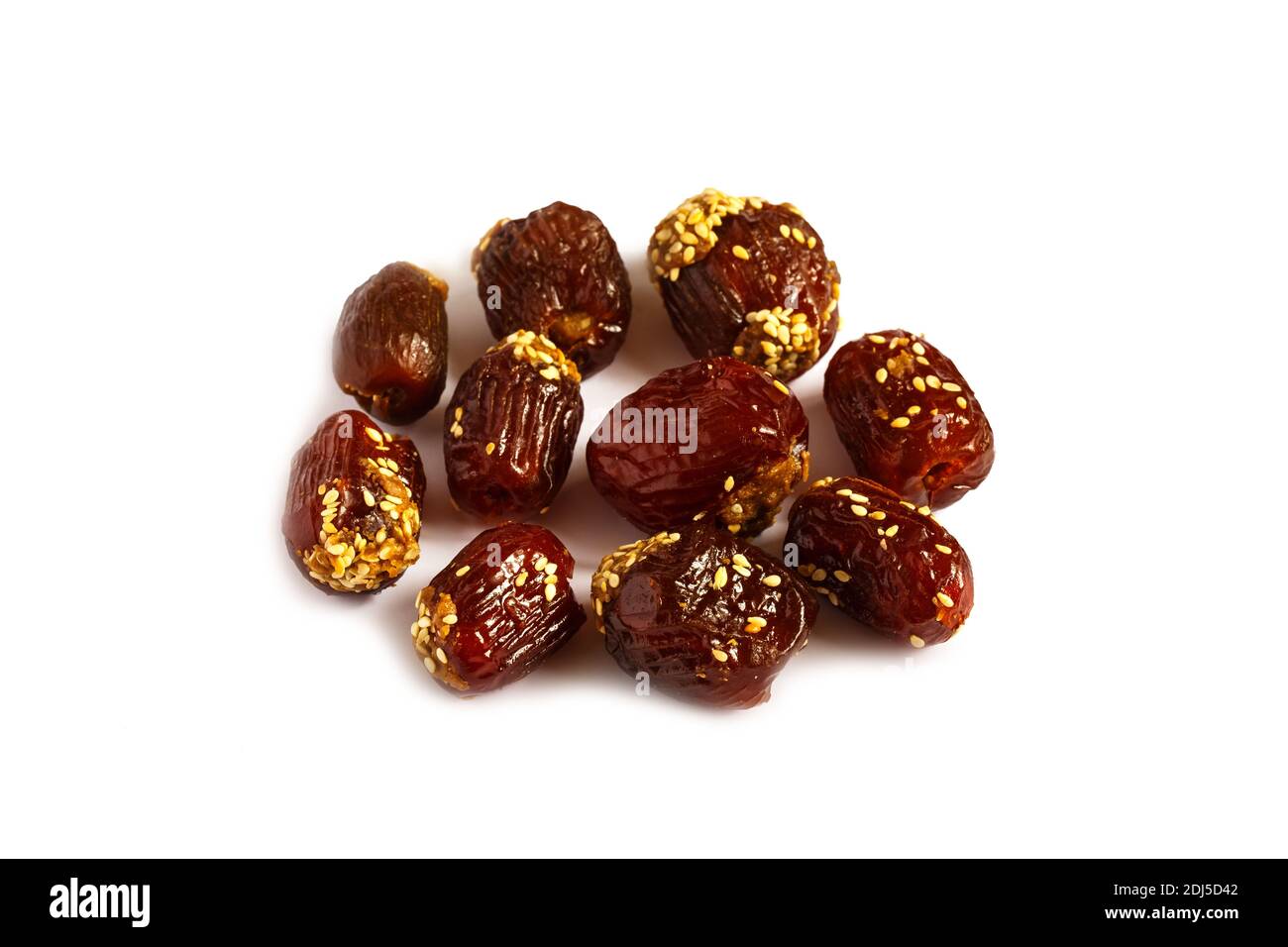 date fruits filled with peanut butter and sprinkled with sesame seeds. Pitted dates isolated on white background Stock Photo