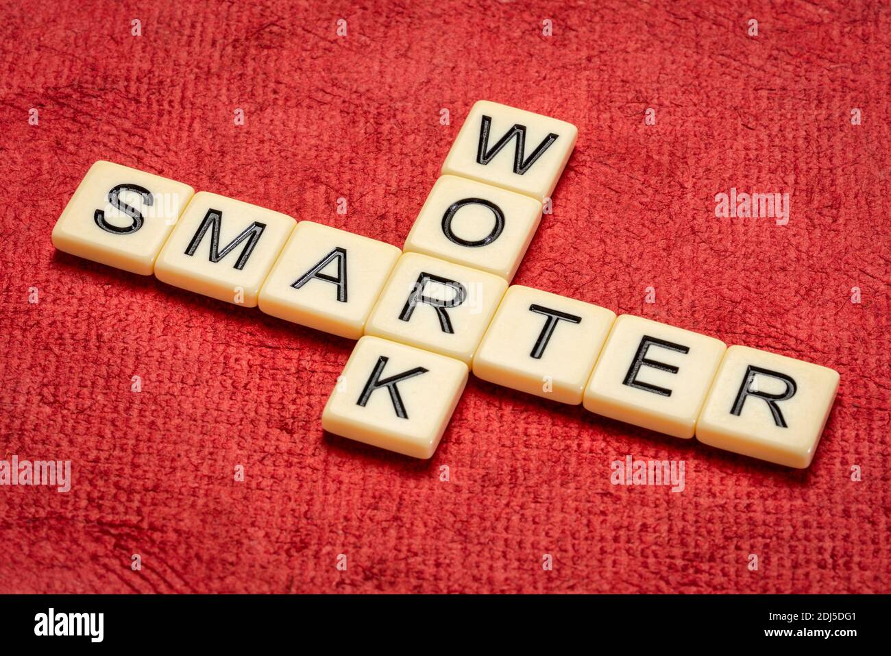 work smarter crossword in ivory letter tiles against textured handmade