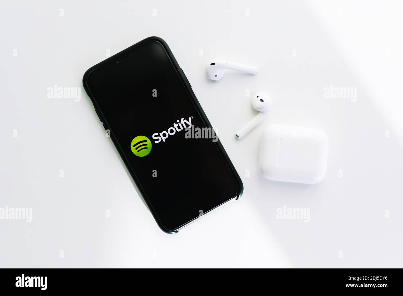 Spotify logo on the iPhone screen, with AirPods. High quality photo Stock  Photo - Alamy