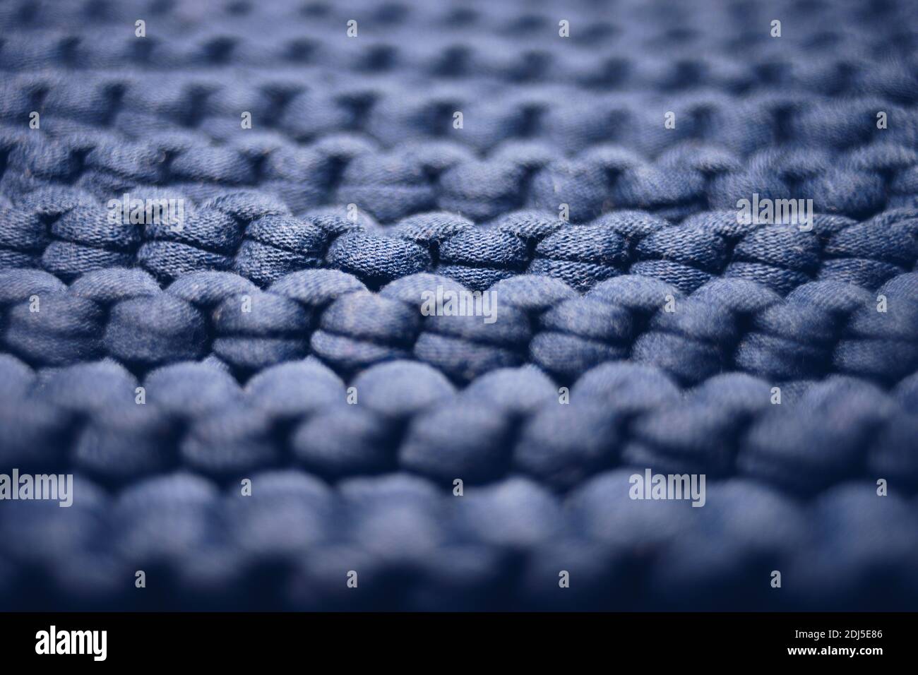 blue background large knitted thread pattern. Stock Photo