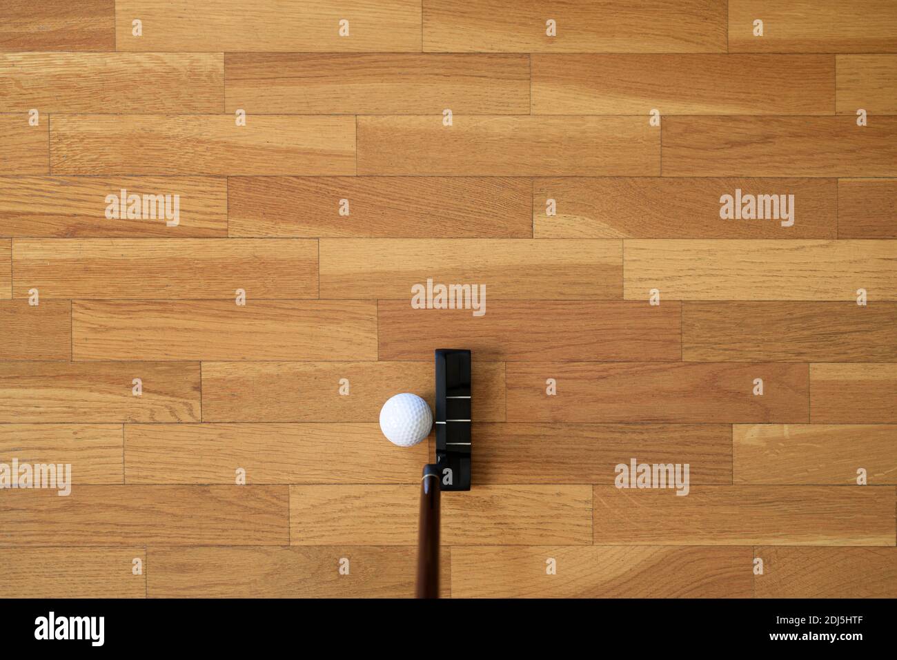 Woman playing mini golf at home Stock Photo
