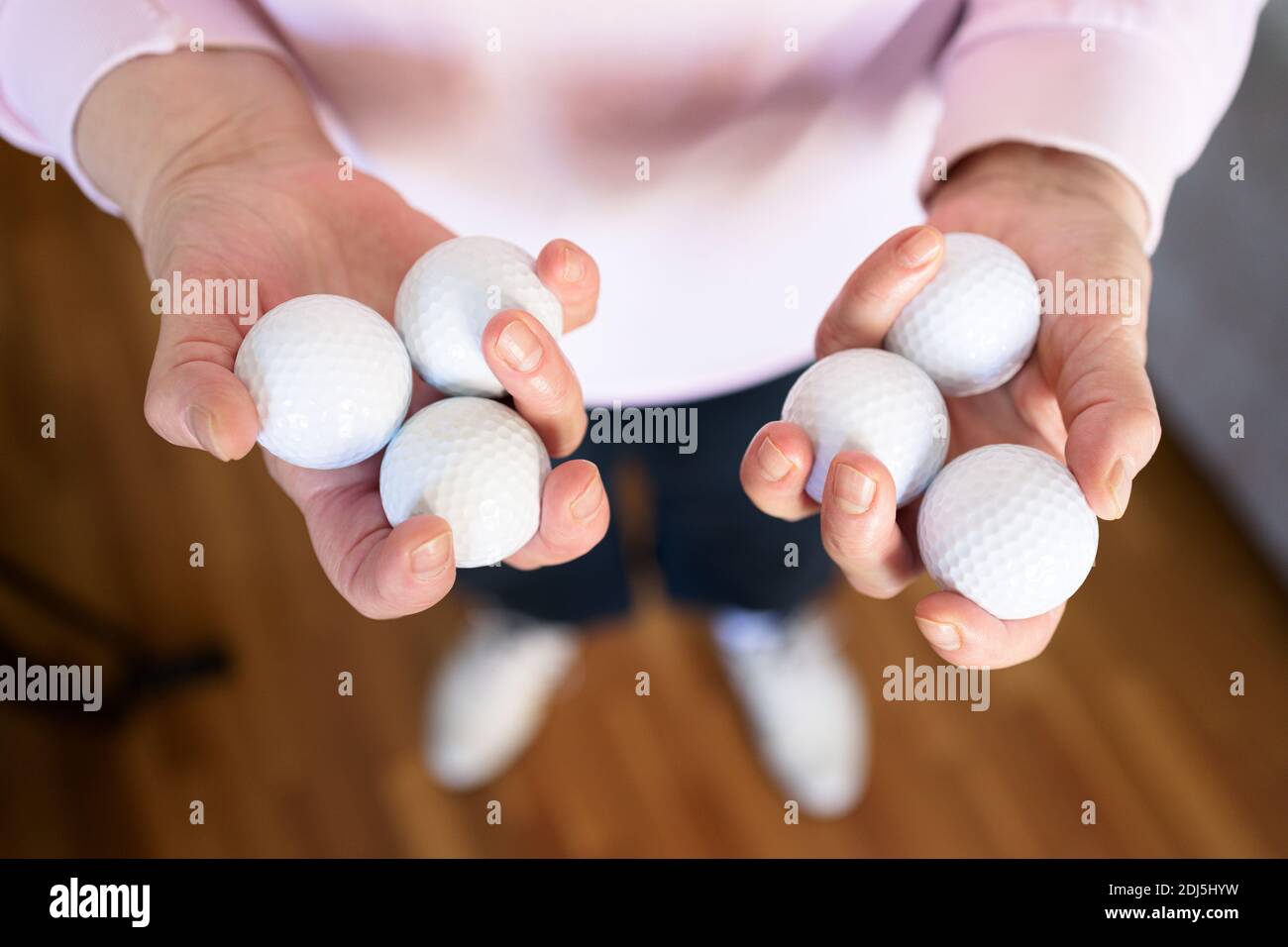 Woman's hands holding several golf balls Stock Photo Alamy