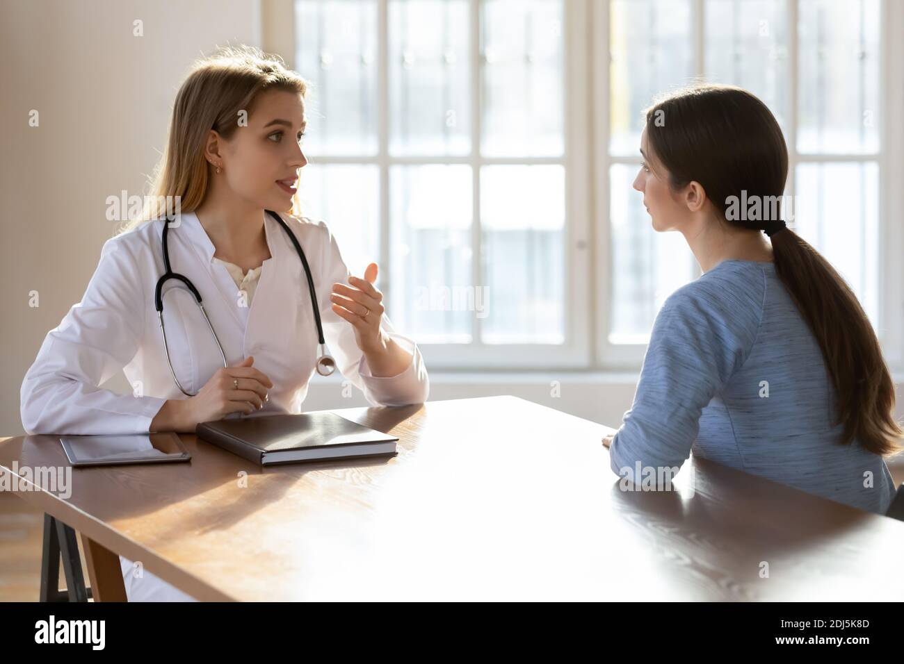 Female doctor have consultation with patient at hospital Stock Photo