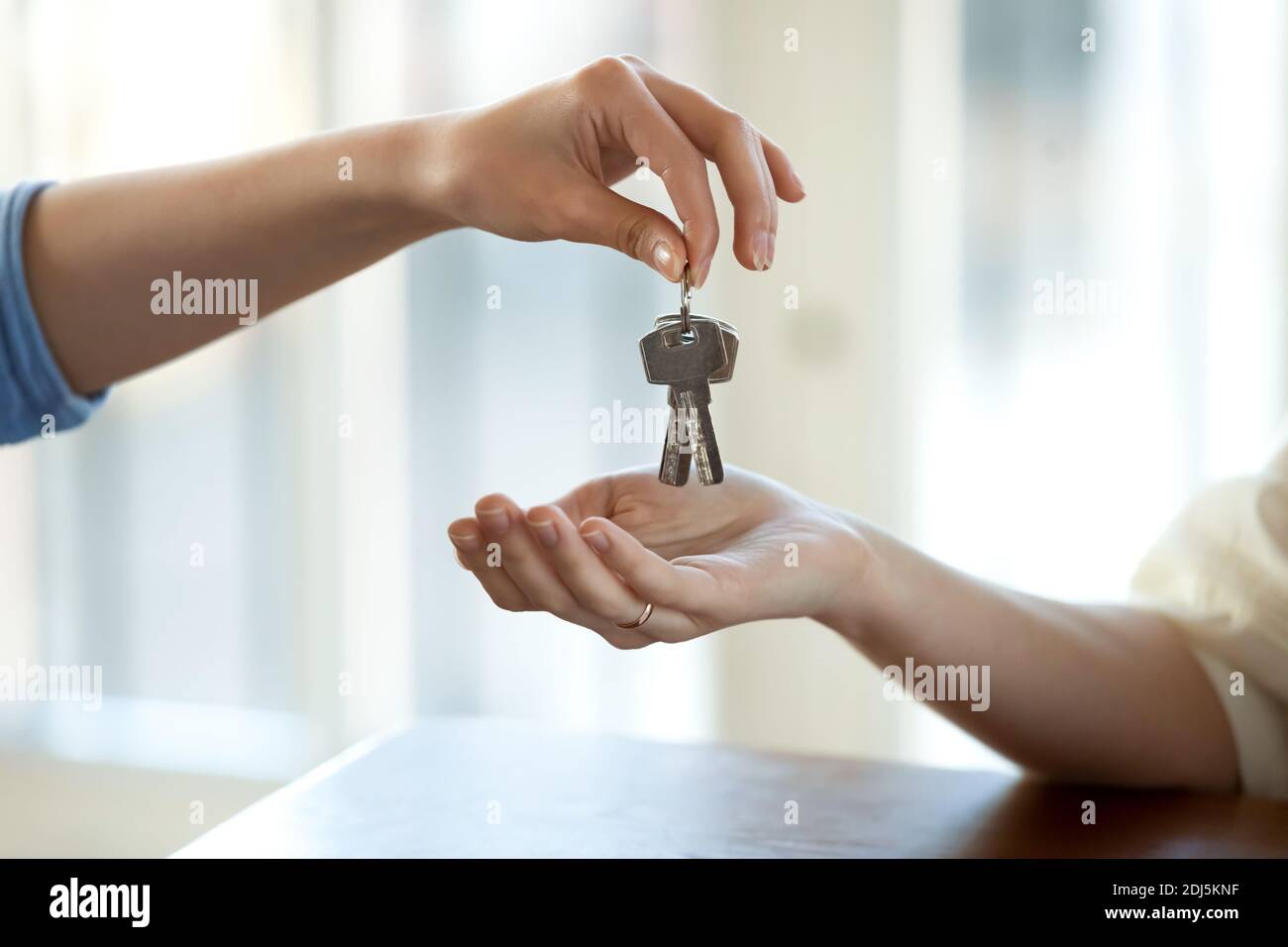 Close up of realtor give keys to female buyer Stock Photo