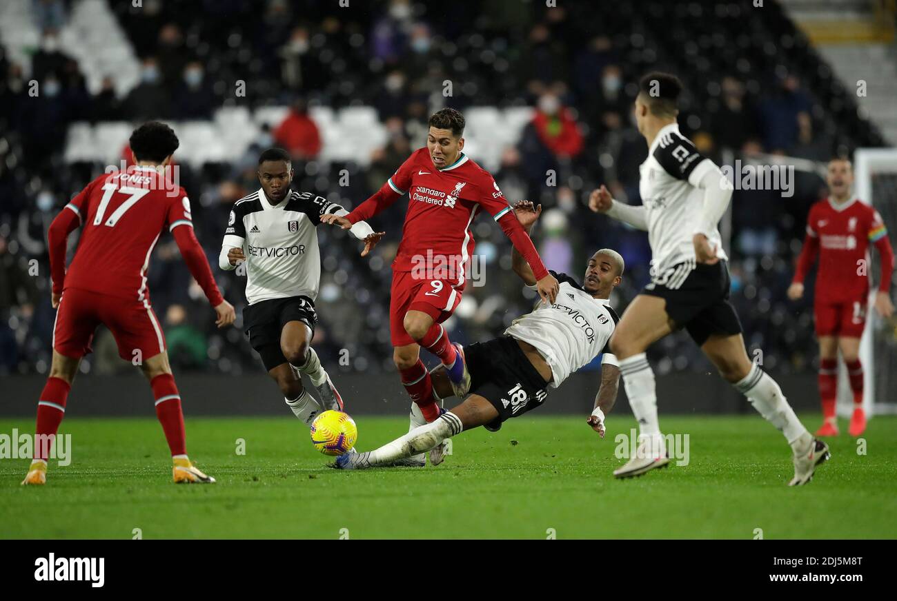 Liverpool's Roberto Firmino (9) is challenged by Fulham's Mario Lemina (18) during the Premier League match at Craven Cottage, London. Stock Photo