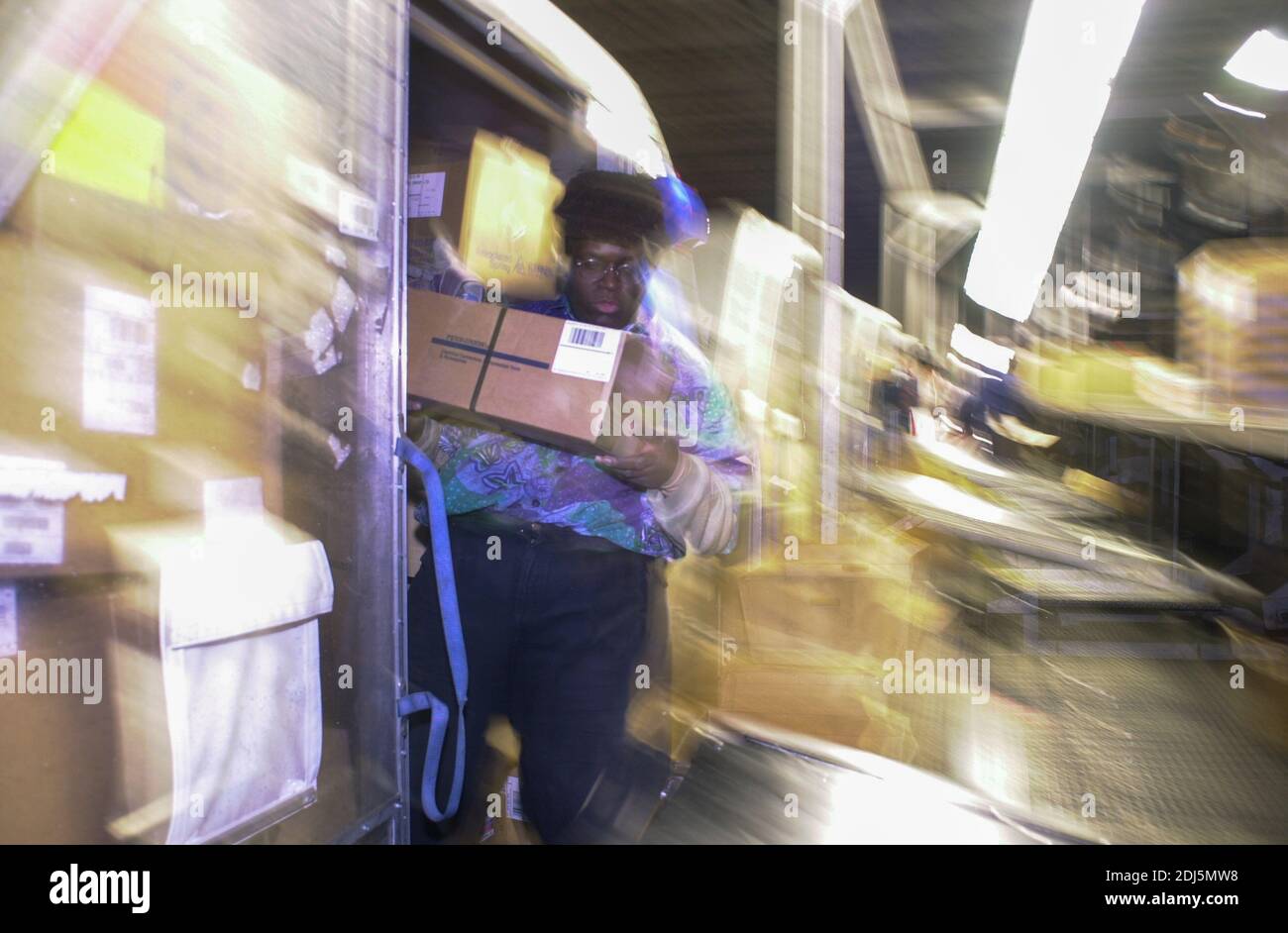 United Parcel Servce employees sort through packages to be shipped throughout the world Thursday, December 14, 2000 at Philadelphia International Airp Stock Photo