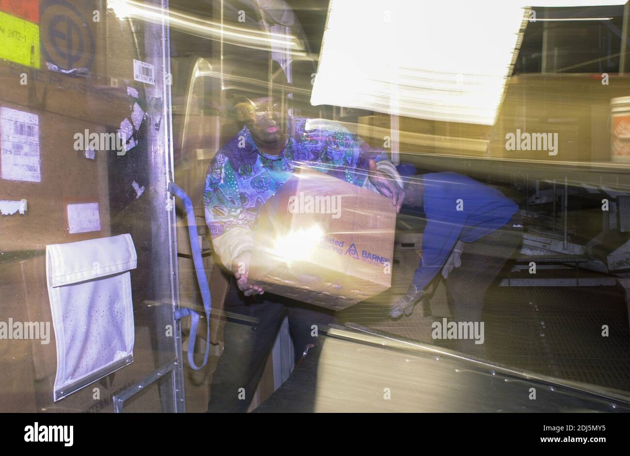 United Parcel Servce employees sort through packages to be shipped throughout the world Thursday, December 14, 2000 at Philadelphia International Airp Stock Photo