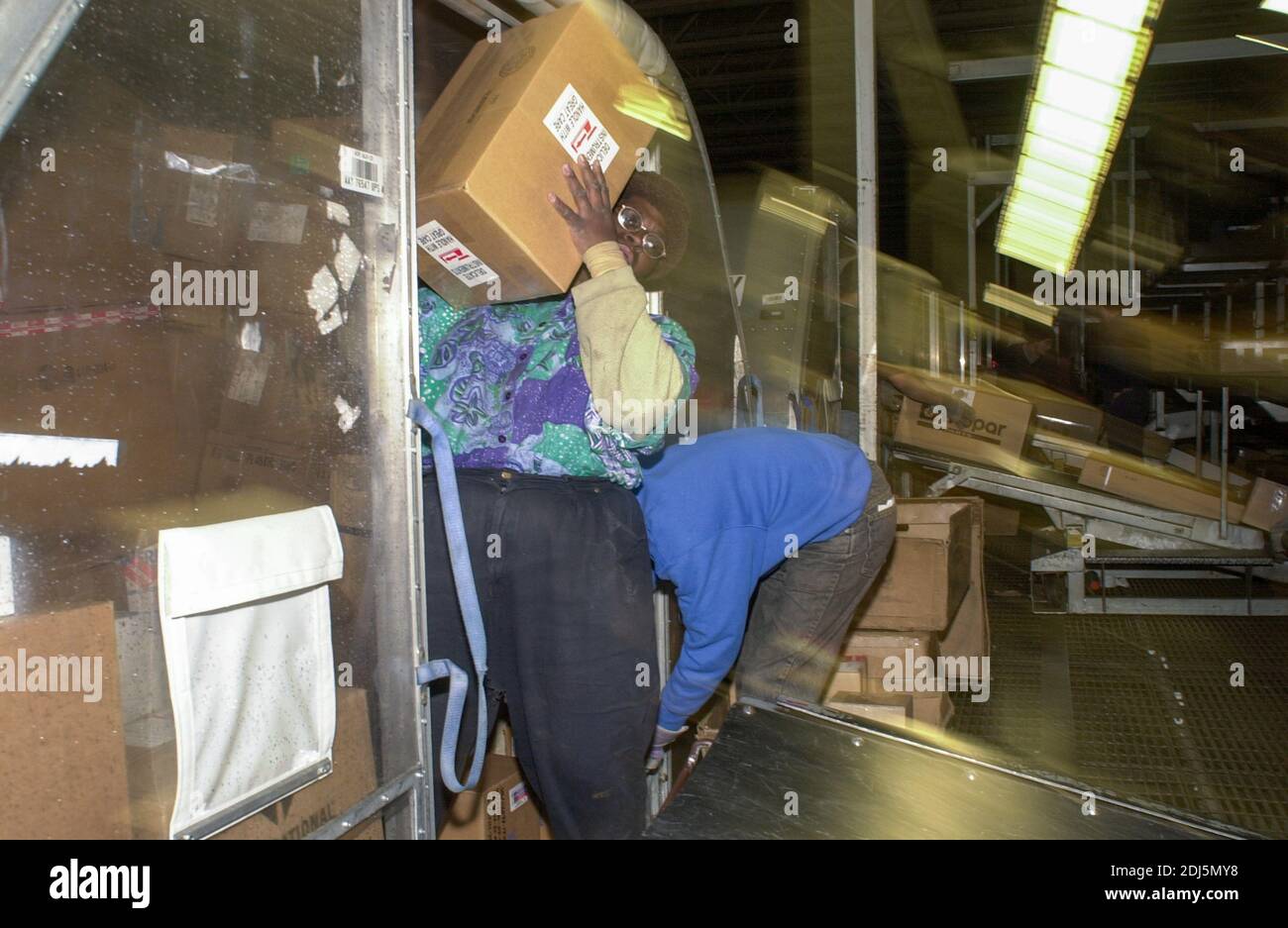 United Parcel Servce employees sort through packages to be shipped throughout the world Thursday, December 14, 2000 at Philadelphia International Airp Stock Photo